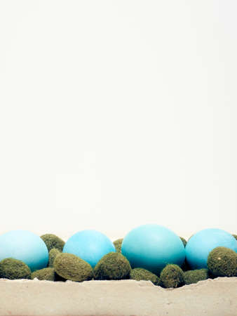 Easter eggs in a carton box on a white background.の写真素材