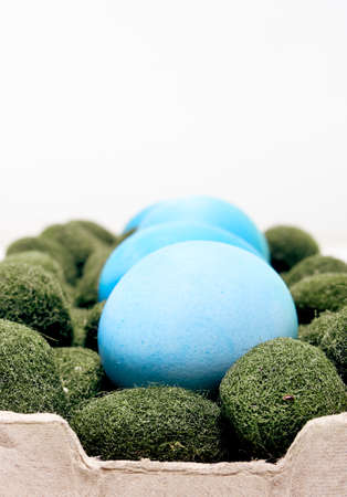 Easter eggs in a carton box on a white background.の写真素材