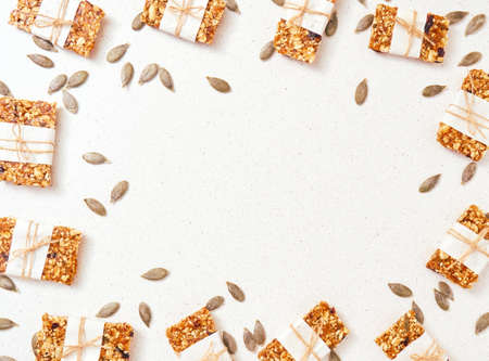Granola bar and ingredients on a white stone table.Top view. Copy space.の写真素材