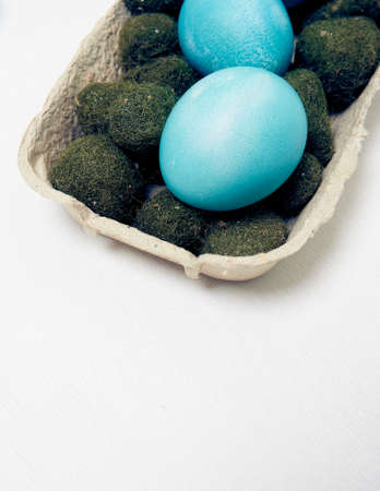 Easter eggs in a carton box on a white background.の写真素材