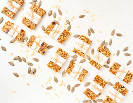 Granola bar and ingredients on a white stone table.Top view. Copy space.の写真素材