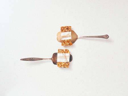 Granola bar and ingredients on a white stone table.Top view.の写真素材