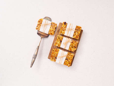 Granola bar and ingredients on a white stone table.Top view.の写真素材