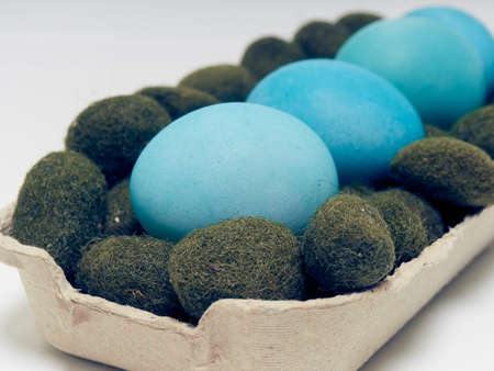 Easter eggs in a carton box on a white background.の写真素材