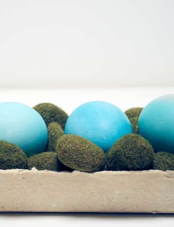 Easter eggs in a carton box on a white background.の写真素材
