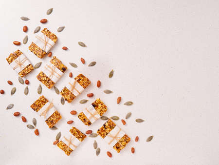 Granola bar and ingredients on a white stone table.Top view. Copy space.の写真素材