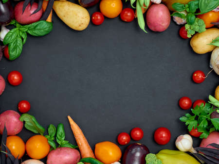 Frame of various vegetables on dark background, top view.の写真素材