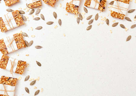 Granola bar and ingredients on a white stone table.Top view. Copy space.の写真素材