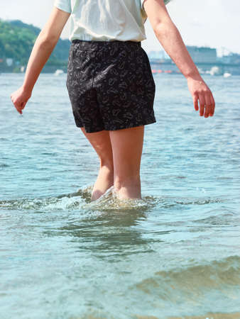 Girl walking in the water, summer vacation concept.の写真素材