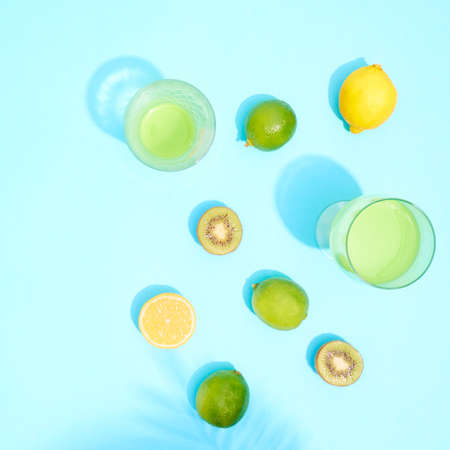 Cocktails in glass with lime and lemon on blue background.の写真素材