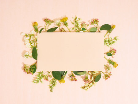 Blank paper with frame of flowers. Flat lay, copy space, top view.の写真素材