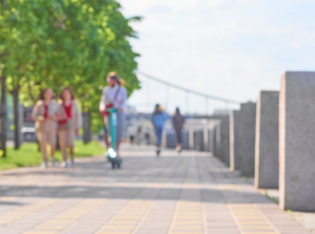 Blurred unfocused city view at day time. Unfocused people in the embankment.の写真素材