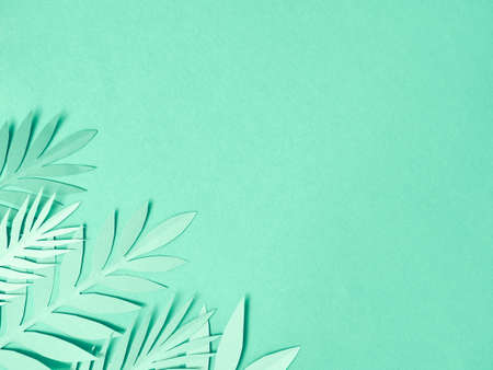 Summer background with colorful paper tropical leaves.