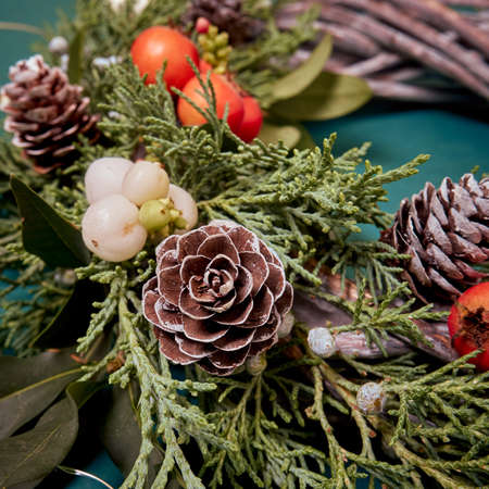 Details of Christmas wreath of fresh spruce, cones and Ñhristmas decorations, close up. New Year decorations.の写真素材