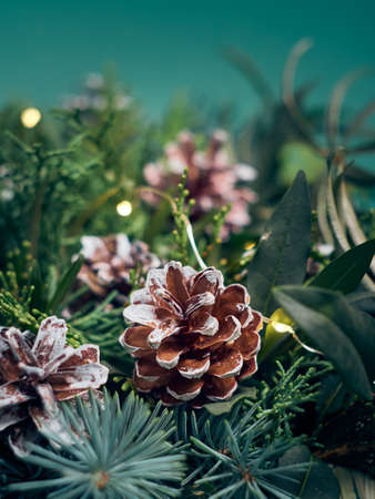 Details of Christmas wreath of fresh spruce, cones and Ñhristmas decorations, close up. New Year decorations.の写真素材