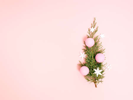 Top view of Christmas composition on pastel pink background. Holiday greeting card with copy space...