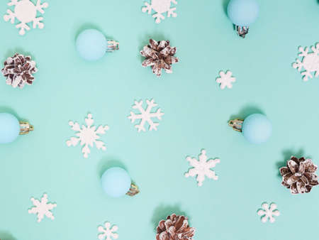 Christmas pattern. New Year decorations on blue background. Snowflakes, cones and Ñhristmas decorations. Flat lay, top view.の写真素材
