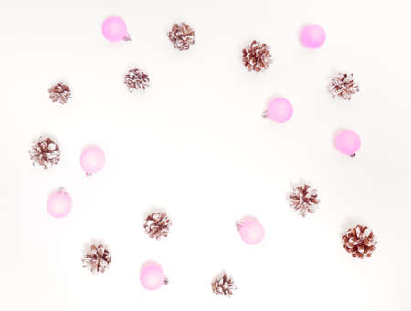 Christmas composition. Cones, pink decorations on white background. Flat lay, top view, copy space.の写真素材