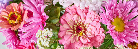 A bouquet of bright flowers on a light background.の写真素材
