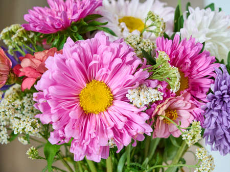 A bouquet of bright flowers on a light background.の写真素材