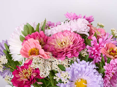 A bouquet of bright flowers on a light background.の写真素材
