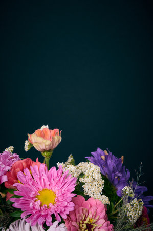 A bouquet of bright flowers on a dark background.の写真素材