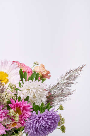 A bouquet of bright flowers on a light background.の写真素材