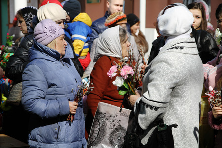 Palm Sunday in Russia, a womans with a pussy willow and flowers in line at churchのeditorial素材