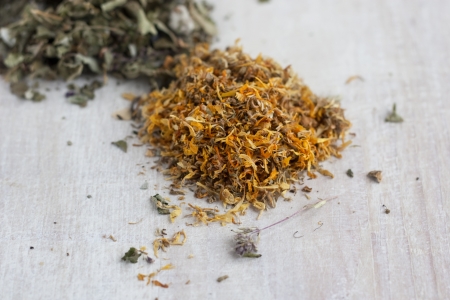 dry herbs - calendula and other on the wood plankの写真素材
