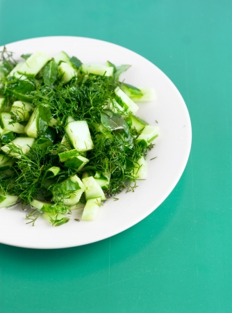 cucumber salad on the round white plate on the green の写真素材