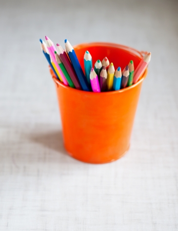 many colored pencils in the bright bucketの写真素材