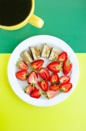 strawberry, chocolate and tea on the yellow and greenの写真素材