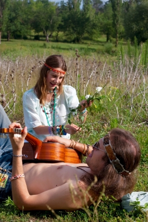  portrait young hippie men and woman on the meadowの写真素材