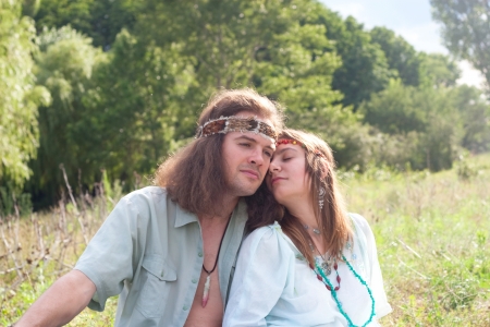 couple young enamoured hippie on the meadowの写真素材