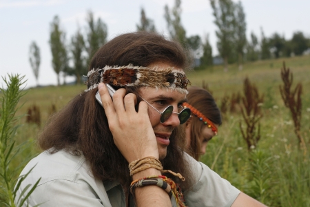 young hippie men speak on the mobile phoneの写真素材