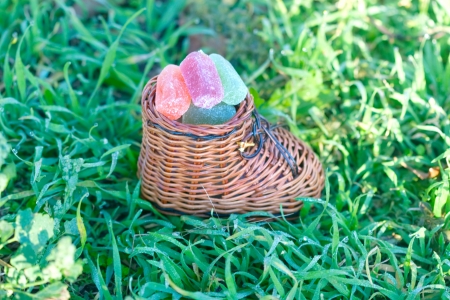 sweet fruit paste in the wood decorative shoe on the green grassの写真素材