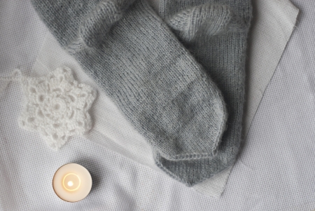 grey knitted socks and crocheted snowflakeの写真素材