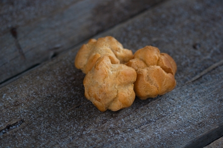 sweet cake on the old dark wood board with snowの写真素材