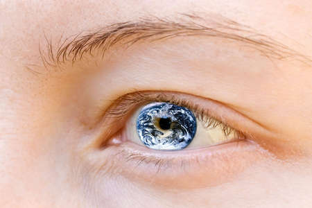 Human eye containing Earth image の写真素材