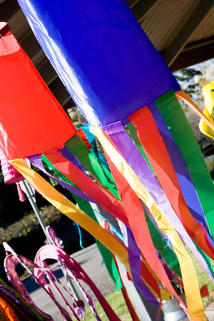 Decorative wind sleeves in various colors in a stall at country market