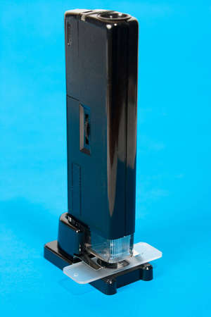 Pocket microscope on blue background