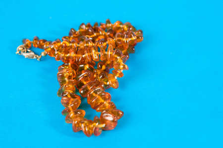 Amber necklace on blue backgroundの写真素材