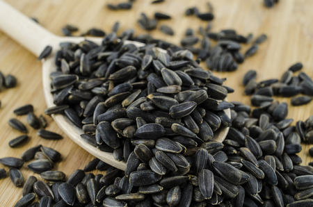 Sunflower seeds macro on wooden spoon.の写真素材