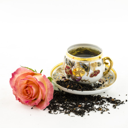 Porcelain tea cup with rose flower and dry tea leavesの写真素材