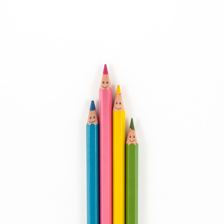 Color pencils with smile faces isolated on whiteの写真素材