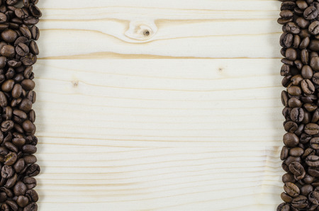 Frame of coffee beans on wooden table. Backgroundの写真素材