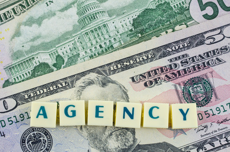 Agency word on dollar background. Finance conceptの写真素材