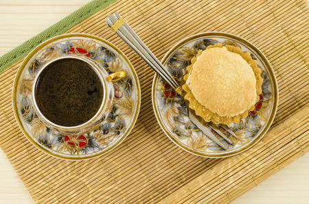 Porcelain coffee cup with flower motif and cakeの写真素材
