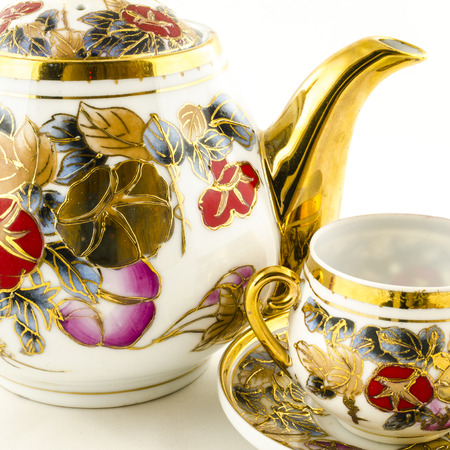 Porcelain tea and coffee set with flower motif on whiteの写真素材