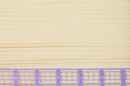 Frame of purple ribbon on wooden backgroundの写真素材